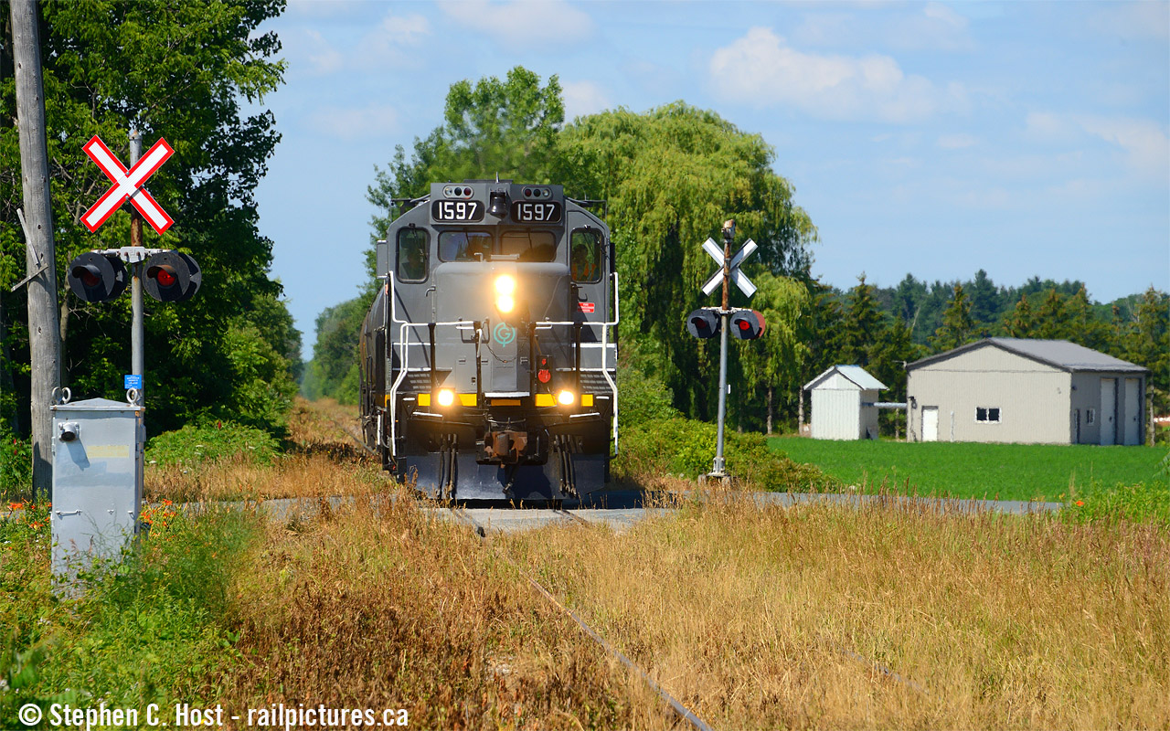 Yup.. underneath all those weeds are tracks... and GIO is eastbound for Tillsonburg on a beautiful summer morning in amish country. What would happen if a spark flies on a hot summer day? Comment below.