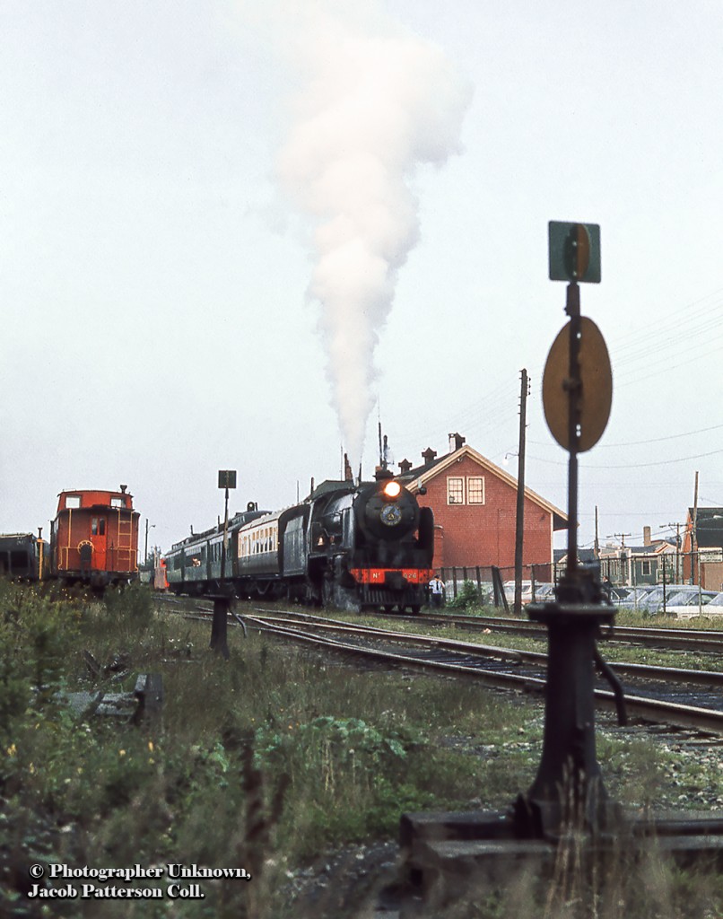 An excursion of the Cape Breton Steam Railway, pulled by Southern Railway (England) 926: Repton, deoarts Glace Ba, Nova Scotia for Port Morien.  Operating from 1973 - 1979, the Cape Breton Steam Railway offered excursions over the former Sydney & Louisburg Railway line.  note the British coach behind Repton.The Repton is a 4-4-0, built in 1934 at Eastleigh Locomotive Works, was part of the Southern Railway's V class, better known as the School's Class as all 40 locomotives were named after English public schools. The locomotive was renumbered to 30926 in 1948 when the Southern Railway was merged into British Railways, and would continue in service until retirement on December 30, 1962. Now in private hands, Repton returned to Eastleigh in 1966 for restoration to Southern 926 before being donated to Steamtown, USA in Bellows Falls, Vermont. In 1974, Steamtown loaned the Repton to the Cape Breton Steam Railway, where it operated alongside Sydney & Louisburg 2-6-0 42. Repton was sold again in 1989 and returned to the UK for restoration to full Southern Railway colours and operation on the North Yorkshire Moors Railway, where she can still be found running today.Bruce Lowe shot a close up view of Repton a few months earlier in July 1974.