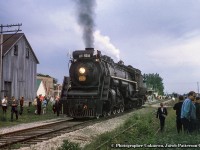 CNR 6218 pauses while headed eastbound during an excursion at Thedford on the Forest Subdivision. while crowds from the train, spotted at the station, surround the engine.  Part of the <a href=https://farm8.staticflickr.com/7033/6624818237_ddf943d88c_z.jpg>station can be seen</a> beyond the tender.  Originally constructed as part of the Toronto – Chicago mainline of the Grand Trunk Railway in late 1856, the Forest Sub ran west from St. Mary’s Junction to Point Edward, just a couple miles north of the Great Western’s Sarnia yards.  The demise of the line came in sections, with Forest to Sarnia abandoned in 1982, Parkhill to Forest in 1986, and finally St. Mary[s junction to Parkhill in 1989.<br><br>More shots along the Forest Sub:<br><a href=http://www.railpictures.ca/?attachment_id=38354>Calmachie, 1959, by Bill Thomson</a><br><a href=http://www.railpictures.ca/?attachment_id=18320>Forest, 1963, by Bill Thomson</a><br><br><i>Original Photographer Unknown, Jacob Patterson Collection Slide.</i>