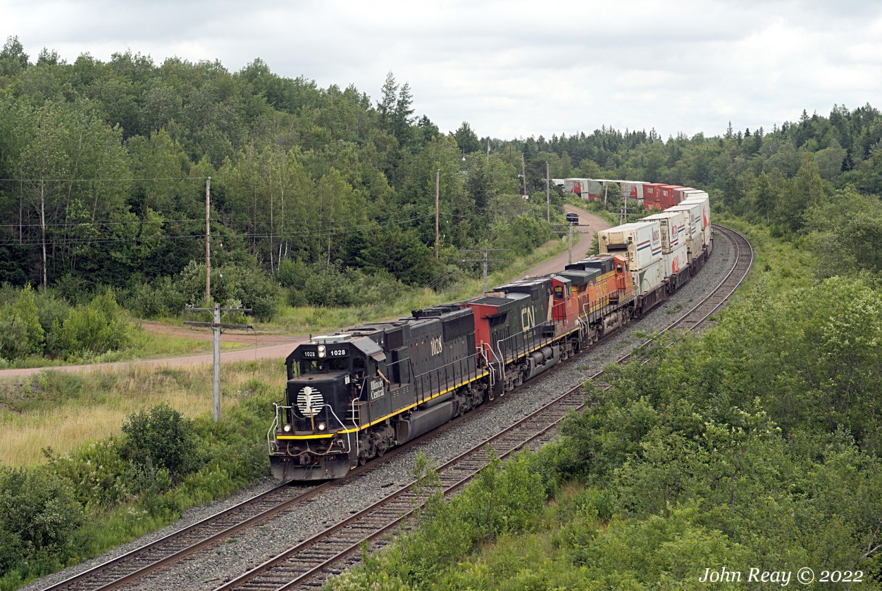 The were a number of railfans chasing CN Q123 out of Halifax today, and no wonder.
Lead unit was as-delivered Illinois Central standard cab SD70 1028, followed by CN 2678
and BNSF 4314 trailing with a well loaded 286 axle train.

July 22nd 2022 @ 13:05, CN Q123 by Springhill Jct. NS.
