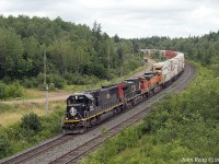 The were a number of railfans chasing CN Q123 out of Halifax today, and no wonder.
Lead unit was as-delivered Illinois Central standard cab SD70 1028, followed by CN 2678
and BNSF 4314 trailing with a well loaded 286 axle train.

July 22nd 2022 @ 13:05, CN Q123 by Springhill Jct. NS.