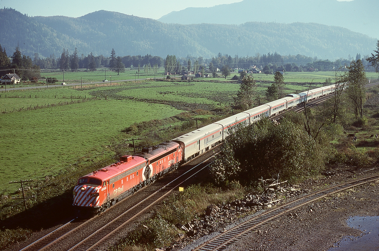 In earlier years, CP operated a rock pit a couple miles west of Agassiz, primarily for rip-rap rock for shoring up eroded banks along the Fraser River.  That is the pit track on the lower right, with No. 1 The Canadian powered by 4068 and 1404 passing by at 0952 PDT on Friday 1978-10-06.  No. 1 was then timetabled 0943 at Agassiz, two miles back, so was wonderfully close to right on time that day.