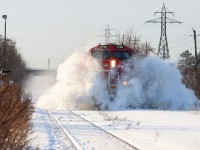 After a significant snowfall 2 nights prior, the north track of CN's Grimsby subdivision between Hamilton and Nelles Road would be used for the first time since the snow. CN ET44ACs 3196 and 3245 would be powering the late CN A421 crossing Ontario Street, Grimsby, where the snow plow had been through shortly prior, causing a large snowbank which would be decimated as seen in the photo.