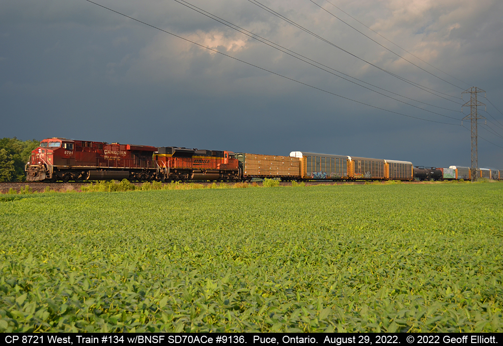 A glimmer of sunshine was all I got.......  CP train #135, with CP 8721 and BNSF SD70ACe #9136, bursts into a 'sucker hole' of sunshine while black clouds and storms formed all around us.  As #135 passed so did the 'sucker hole' but not before we made the most of it.