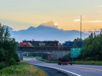 At sunrise, Q121 departs Moncton, approaching Berry Millls, New Brunswick. One of the few GECX engines that haven't been repainted yet trails. 