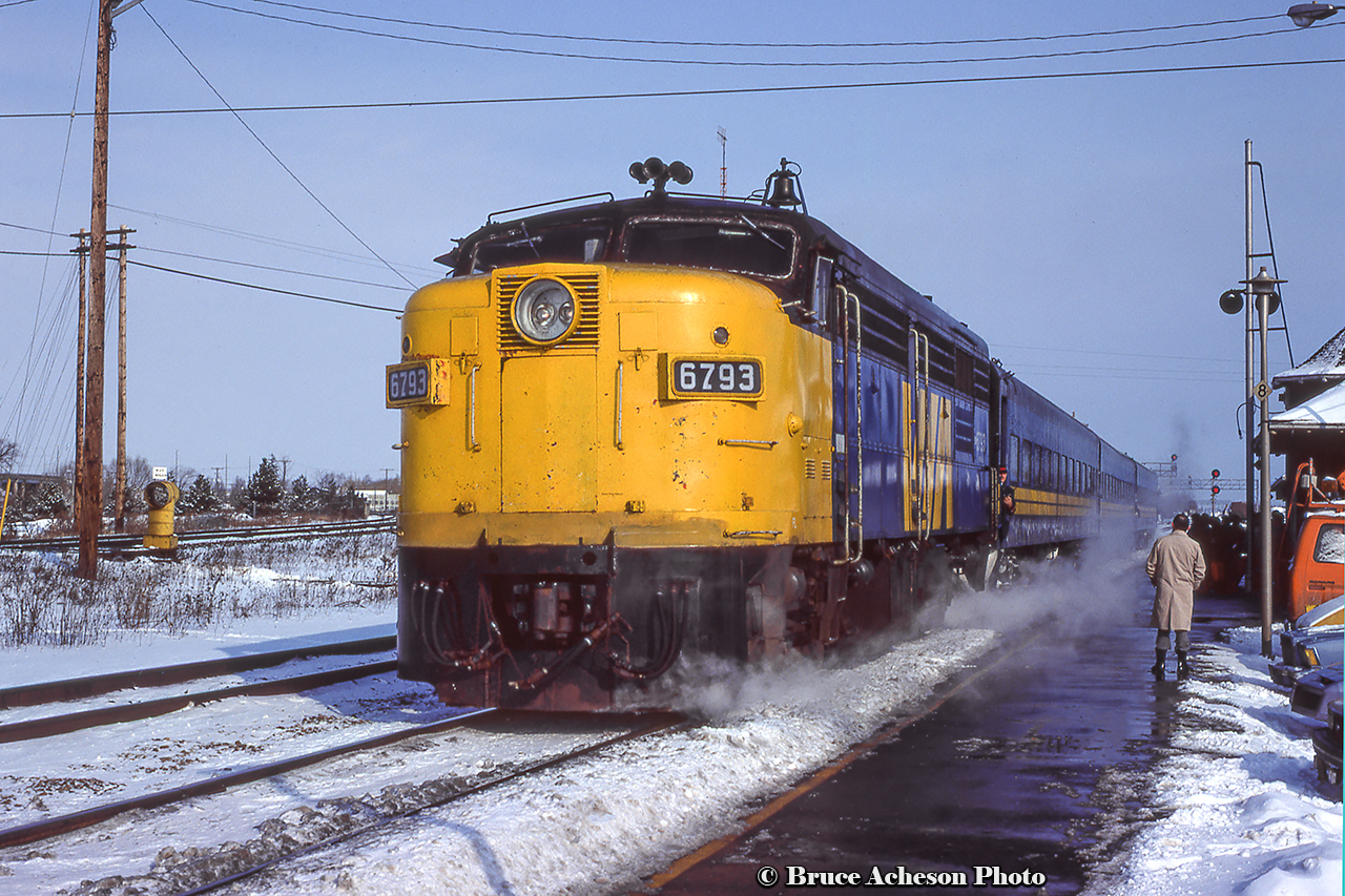 With trainmen in the doorways, VIA 73 arrives at Burlington West on a cold winter's day.  Note the waybill "catcher" barrels in the distance on the Halton Sub.