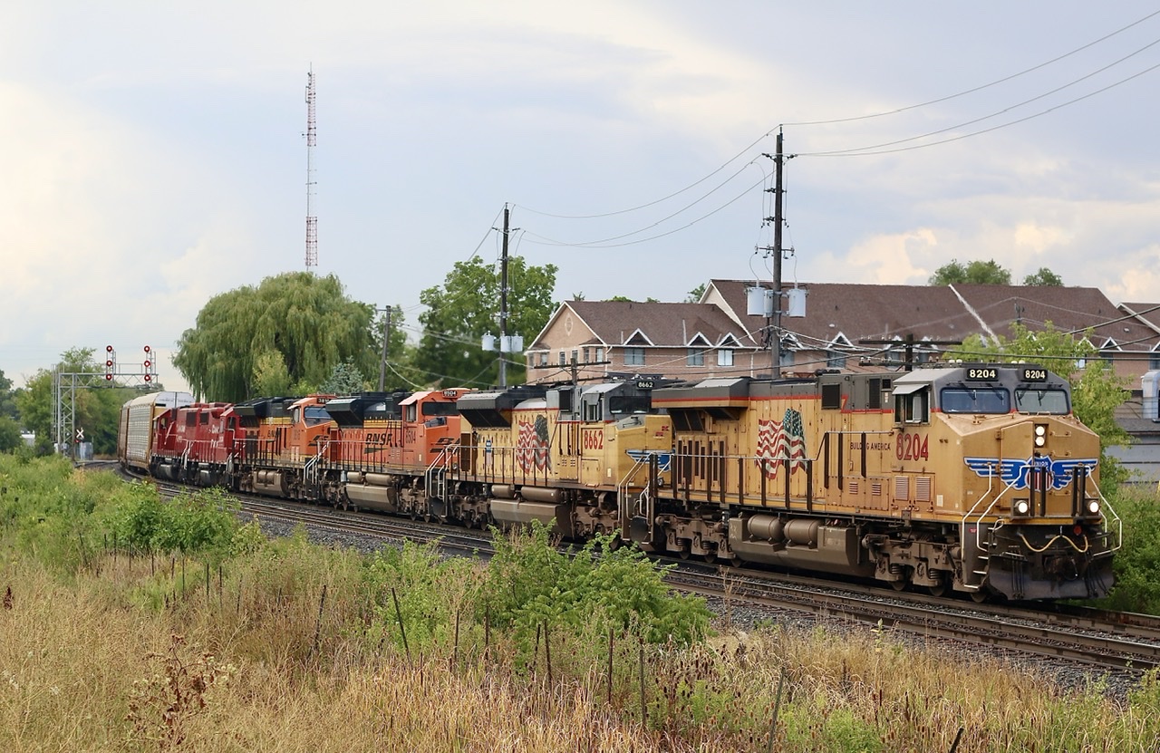 Well this certainly was an interesting train, and that is the only reason why I’m submitting this shot. This is my desperation spot and not really a favourite spot but more a location that works for eastbounds in the afternoon or when I’m in a rush to get to work, LoL. Unfortunately the weather wasn’t the best but at least the heavy rain held off a bit longer. Tuesday on the Galt subdivision west of Guelph junction quickly turned into a bit of a disaster with two units reporting as completely out of fuel. ( How one would not know a multi million dollar locomotive is out of fuel is beyond me ) Nevertheless the crews never made it to their final destinations so that thankfully made Wednesday a lot more colourful as multiple CP 234’s and power rounded the curve in Streetsville, finally headed to Toronto. A nice mix of power from three railroads on the head end and almost all elephant style. Thanks precision railroading, LoL.