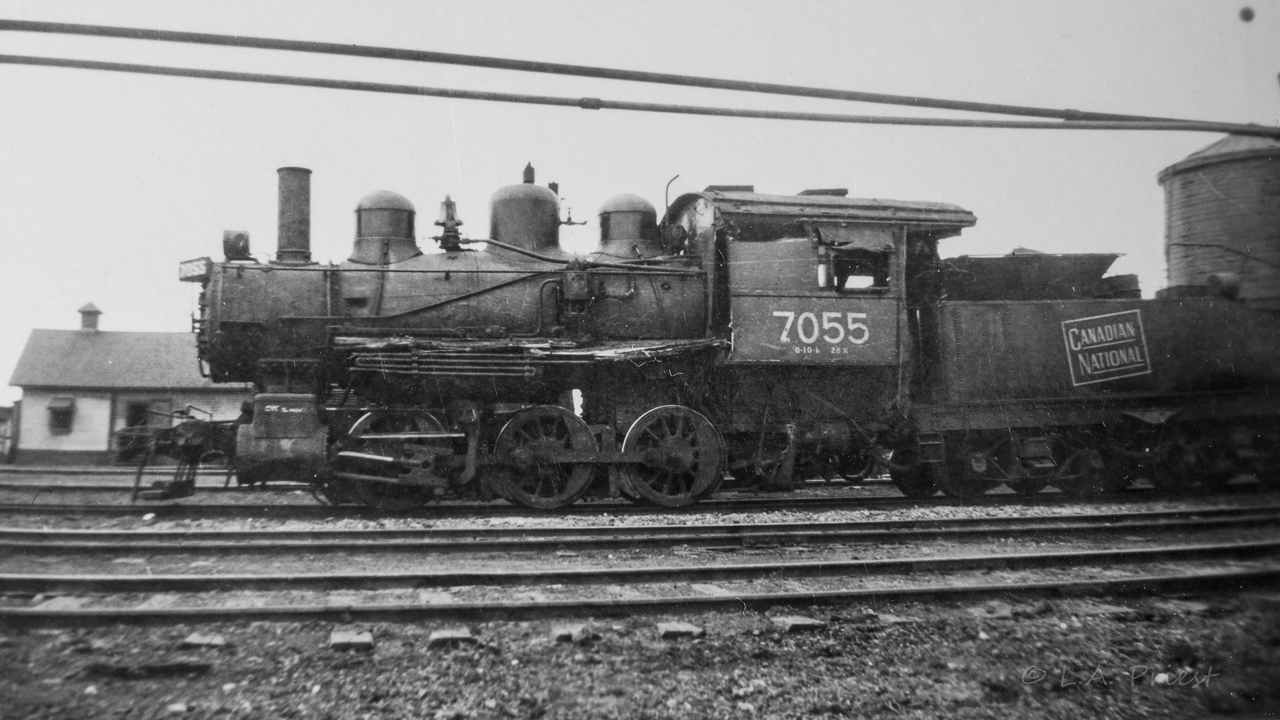 A CN 0-6-0 from the contact prints taken by my Dad. A short look turned up a few facts on these switchers. They were built for Canadian Northern by CLC between the dates of 1912 and 1914 (number series 7031 to 7065 [from CNRHA]). The 7055 is shown retired in Sept. of 1950 (Trainweb.org). This last fact helps to date this picture. As can be seen, the main rods are missing and the 7055 is in a rather run down state. Scrapping must not be be long in the future at the time this photo was taken. Location is unknown.