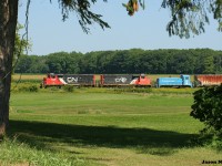 CN L568 with 9449 and 9639 as well as SSRX 911 in tow are just at the town limits as they approach Baden, Ontario heading westbound to Stratford on the Guelph Subdivision. The switcher was destined for the Roslin Enterprises facility, which is situated in the old Dana Corporation frame plant in St. Marys, Ontario. 