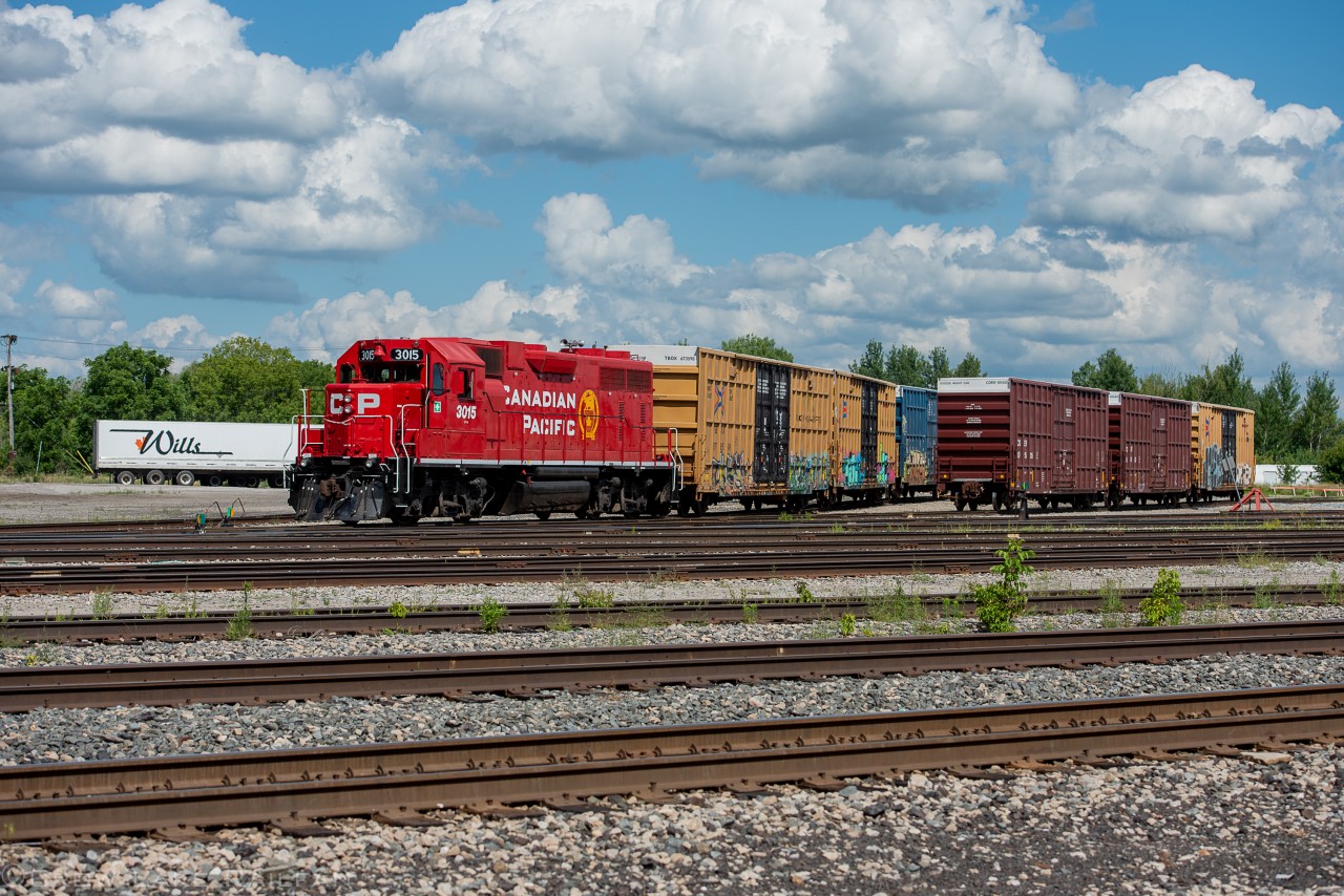 CP G65 (formerly F55) spots a couple cars for Wills Transfer with a rebuilt GP38 taking charge.