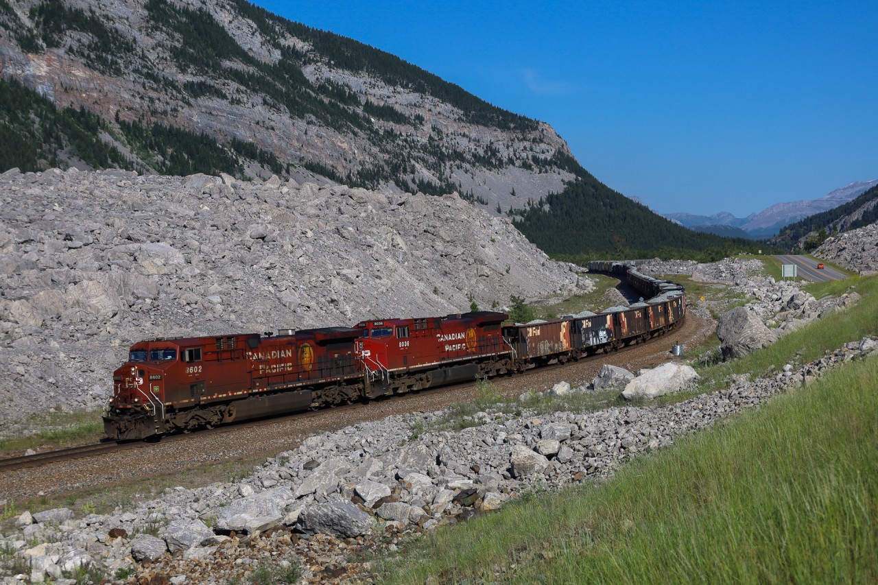 CP 318 rolls past the infamous Frank Slide on a beautiful morning in Crowsnest Pass