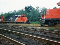 Back in September 1993 CN completed a large-scale bridge replacement west of Paris on the Dundas Subdivision. This resulted in CN rerouting trains not only on their Guelph Subdivision, but also detouring across Canadian Pacific’s Galt Subdivision for several days. In the west, the trains would begin their journey to the Galt Subdivision through the interchange track at Woodstock then onto the CP St. Thomas Subdivision for a short stretch before reaching the Galt mainline.
<br>
Here the CP Woodstock Afternoon Job with CP GP9's 8243 and 8207 take priority as they head to the Cami facility meeting CN 392 with SD40’s 5055, 5029 and 5043 as they wait to proceed eastbound on the CP St. Thomas Subdivision on the CN-CP interchange track.