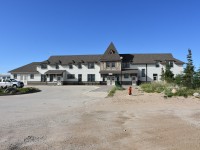 I waited for quite some time to see if that silver pickup truck would move out of the shot but it wasn't to be. The Churchill, MB station/Parks Canada building looks great in this mid-morning street side full front view with the clear blue sky backdrop. The double door entrance under the Churchill name plate leads directly to the VIA rail ticket counter and the Parks Canada reception area for the museum tour. To the left of the doors are some original station waiting room benches and the walk-through museum area, and to the right are public washrooms and an elevator to Parks Canada offices on the second floor. Equipment from this mornings VIA #693 sits idle on the station track waiting for its next load of passengers later in the evening.