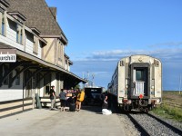VIA 693 had backed into Churchill station for an on time arrival at 09:00 on the morning of August 2, 2022. That same equipment consist was fueled, watered, and otherwise prepared for a southbound journey as VIA 690 that same evening. Here we see passengers gathered on the platform at 19:05 with their checked baggage piled high in several locations waiting for it to be loaded into the VIA service truck parked between the station and passenger equipment. Along with the checked bags to be brought forward to the baggage car, the maintenance person was also loading soiled linens from the Chateau sleeping car. Passenger vans from various tour companies also travelled onto the platform to deliver luggage directly to the baggage car for departing Churchill visitors as well. Other than the odd passenger getting in the way, the whole operation of loading luggage and moving vehicles along the platform was a well orchestrated dance that had obviously occurred many times before.