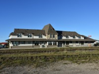 For those who like full frontal views, here's a platform side shot of the former CN station, now VIA/Parks Canada building in beautiful downtown Churchill, MB. A pleasant mid-summer breeze has the Canadian flag stretched out nicely for the photo, and the old baggage dolly on the platform is a reminder of how luggage was once moved about prior to pickup trucks becoming the new normal. It won't be long before some repairs and a fresh coat of paint will be required on this stately old building, but it looks absolutely wonderful in the bright sunshine and super blue sky background on this early evening of August 2, 2022.