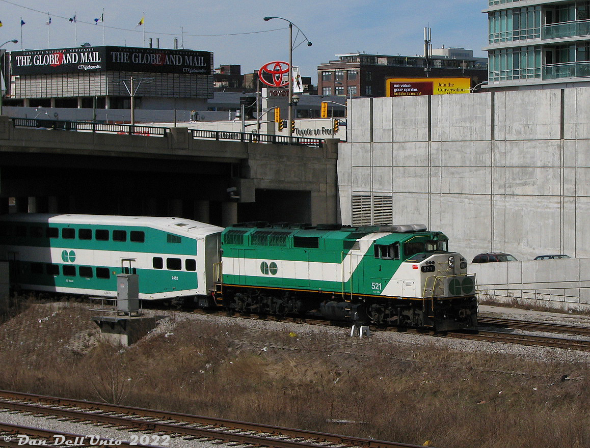 Slow weekday afternoons in the Union Station Rail Corridor were always good for a few trains: some Lakeshore West-East runs, a few VIAs, and "The Bramalea Flip" afternoon Georgetown-line service between Brampton (Bramalea) and Toronto. Here, GO Transit F59PH 521 ducks under Spadina Avenue, departing Union Station on the tail end of afternoon train #263 to Bramalea station. She will be back later with #266, and then depart around 3pm again on #281 for the downtown Brampton station.

Newly minted from GMD in July 1988, GO 521 ran in Toronto commuter service for two decades until retirement and sale to RB Leasing (RBRX) in 2009, eventually ending up on NC Dot (North Carolina) as cab control unit 105.

The Toyota on Front auto dealership and the National Post newspaper building in the background have both since been demolished and redeveloped with new condos.