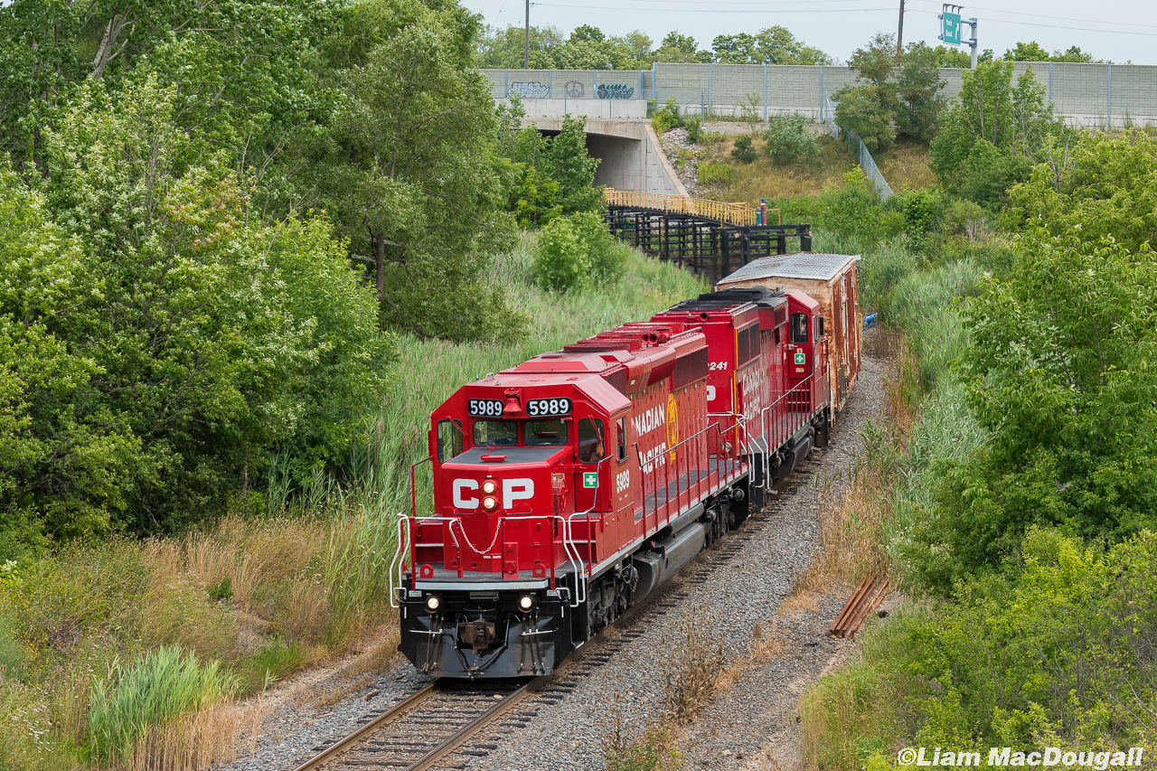 On a hot afternoon, CP 5989 leads a CWR train southbound on the Hamilton Sub preparing to dump a couple rails around Desjardins.