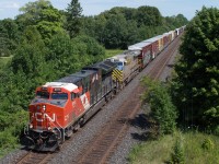 CN 397 blasts through Creditville behind CN 3015 and CN 3939.