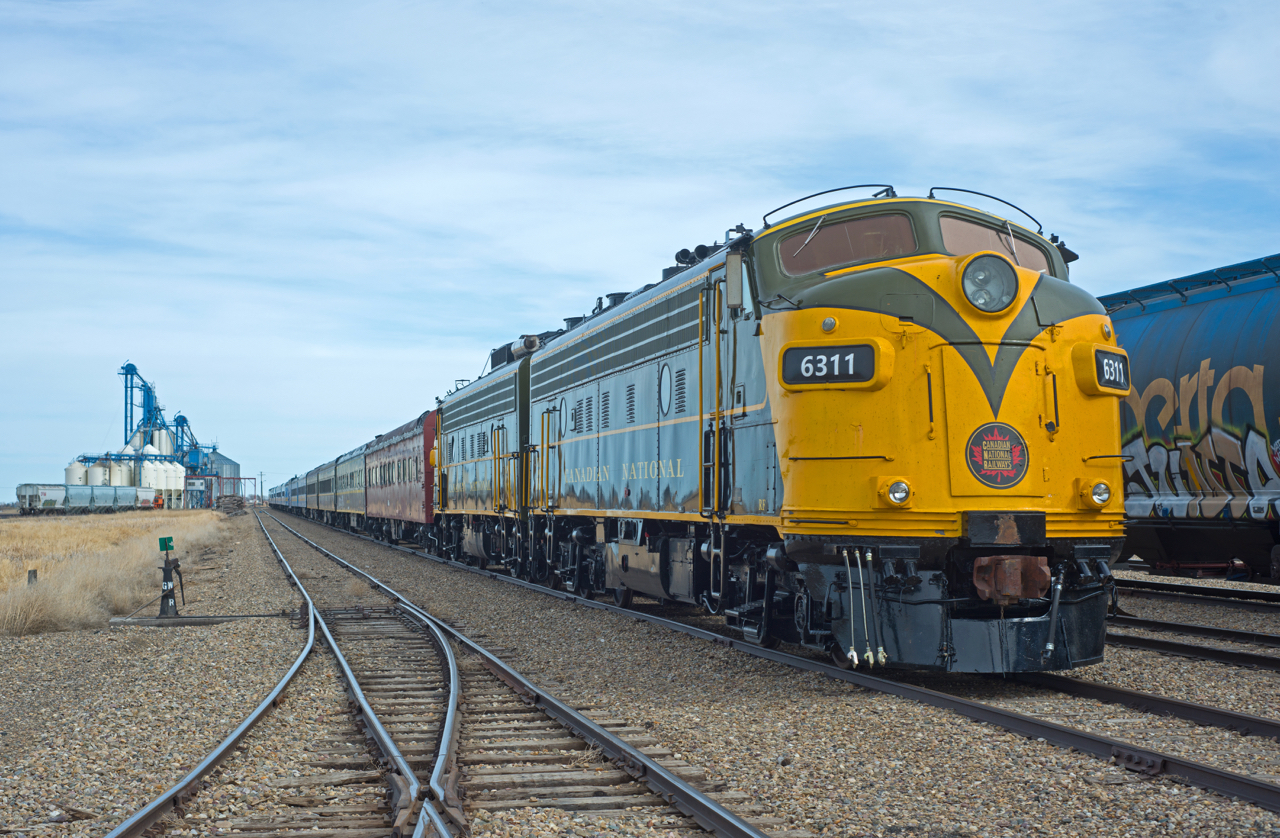 A large group of Eastend Scenic Railtours' equipment is seen tied down in Great Western's Assiniboia yard for the weekend. Two more F's, and a few more coaches would be lifted at Shaunavon for the trip to Eastend.