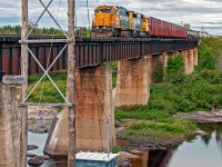 No longer legible, the old mile marker for Mile 110.3 Kapuskasing Sub still adorns the old code line pole at the edge of the Missinaibi River. Above, Ontario Northland freight 516 rolls with GP38-2 1801 leading GP40-2 2201 and a healthy string of cars. The trailing string of hoppers will be dropped at Opasatika (destined for the Agrium Mine south of Opaz Junction) while the headend eight cars will continue through to Kapuskasing where the crew will meet their counterpart ex Cochrane and exchange traffic before returning. 