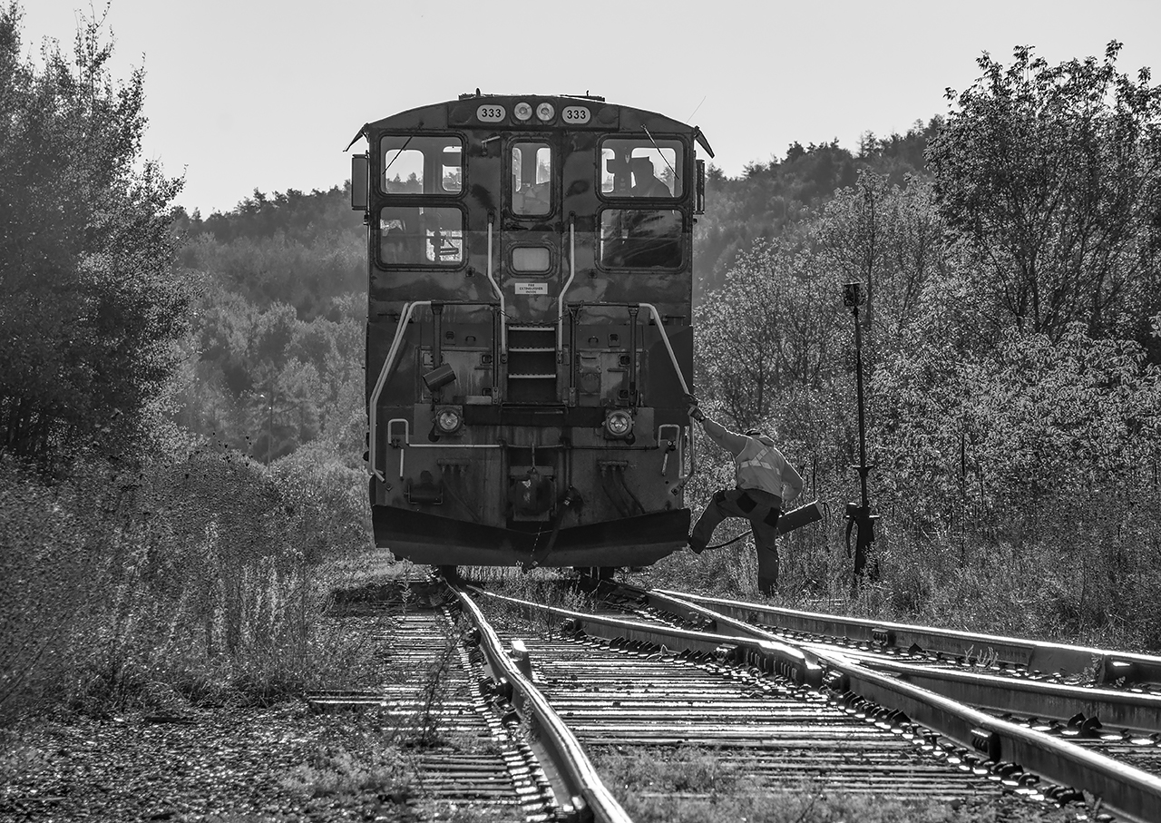SBU in hand, the conductor detrains at the south yard switch to line his unit onto their waiting cut of cars.