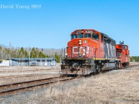 Tipped off there was a work train ordered up ex Hornepayne that morning, my good friend Kyle Stefanovic and I set out of Thunder Bay mid morning bound for Jellicoe- working on a hunch solely based off a train symbol which had been used previously for crews pulling the Kinghorn that could have been used for anything else! There were no guarantees we would see anything other than what was left of the former crew change point in the middle of nowhere Ontario. We arrived shortly after 14:00 to a lifeless scene. The trees barren, the ground brown and dead. It was a warm and beautiful spring day but the colour green was still a month and change away... The three track yard had been removed while the mainline, siding and wye remained intact as well as the boarded up bunkhouse. As we sat in my little '04 Honda Civic trying to figure out an ETA, if in fact they were even destined for the Kinghorn. Knowing the order time, (what we figured the) run time on the Caramat Sub to Longlac Jct was plus the run time to Jellicoe at the lowly speed of 15mph it'd be anytime around the 15:00 hour. As we continued to chat to our amazement there was a chirp over the radio... 
<br><br>"Ok ahead 908."
<br><br>Unbelievable! Our excitement could not be contained as our hunch had paid off. The lights of CN SD40-2W 5305 rounded the curve at the east end of the former yard along the mainline. I composed this image of the veteran unit and old GTW caboose 79047 running down the mainline past the abandoned and boarded up bunkhouse.<br><br>The crew setoff GTW 79047 at the west end of the siding, before returning to their train of empty CWR cars left at the east siding switch. The train would be pulled into the siding and left behind as the crew coupled up to the awaiting caboose ahead of them and shove some 40 plus miles west to another waiting CWR train sitting in the middle of the bush west of Orient Bay. We followed to Beardmore where we were forced to break off the chase due to commitments back in town. 