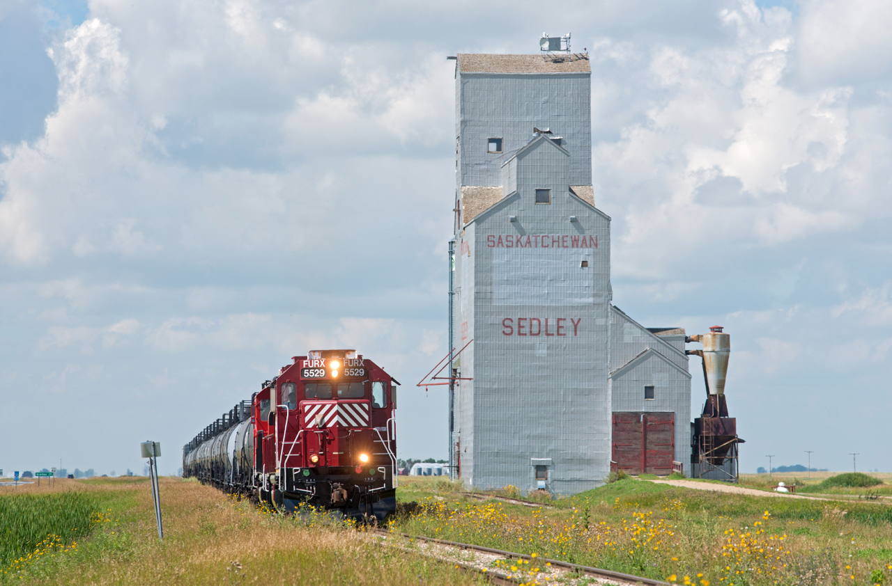 In this scene the Stewart Southern Railway is around 25 miles into it's 80 mile journey between Richardson and Stoughton, all of which is 10mph.  There are quite a few elevators along the line, including this one at Sedley, however it takes some patience to chase this operation.