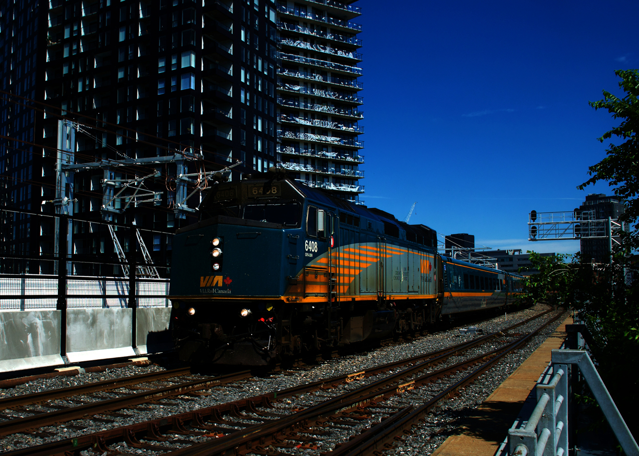 VIA 65 has just left Central Station as it approaches the out of use Wellington Tower. At left is the right of way and catenary for the not yet open REM light rail project. To say this scene has changed a lot recently would be quite an understatement.