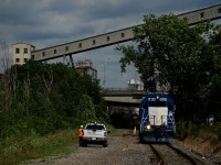 A foreman is waiting to put a derail back onto the CN Wharf Spur as soon as the Pointe St-Charles Switcher clears. It is heading from the Port of Montreal to its namesake yard with ex-GMTX CN 4904 leading.