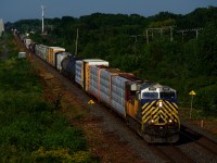 Ex-CREX CN 3969 leads CN 310 eastbound through Beaconsfield, with even newer to CN ex-CREX unit CN 2756 operating mid-train on this lengthy manifest train. 