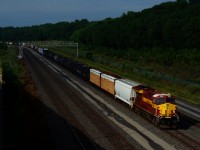 The sun is briefly out as CN 310 with the WC heritage unit leading slowly heads east after setting off cars near Turcot Ouest. A bit further ahead the train will stop until the conductor is taxied back to the head end.
