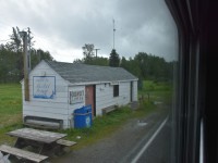 This shot isn't as pretty as others I've been posting, but it was my only opportunity to catch Thicket Portage railway station at Mile 184.3 on Hudson Bay Railway's Thicket Sub with my Nikon. This was on my return trip from Churchill, MB. and it is the best of several I snapped through the tinted, dirty, rain spotted glass of my bedroom D in sleeping car VIA 8229 Chateau Viger. This quaint building sits next to the tracks near the intersection of 1st Street & South Railway Avenue in Thicket Portage. On my journey up to Churchill I snapped a couple of photos with my iPhone and they show that this is quite the gathering place at train time.
A few facts about Thicket Portage;
Thicket Portage is a very remote community in northern Manitoba located on the Hudson Bay Railway.
The community receives passenger rail service at the Thicket Portage railway station.
The community has no all-weather road access.
The community is serviced by year round train access, local airport, and winter ice roads.