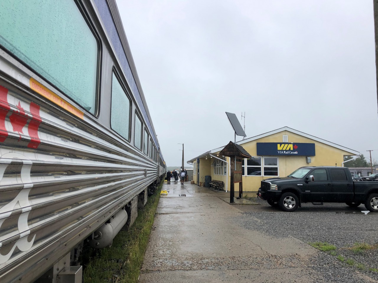 VIA #692 (Churchill to Winnipeg) is backed into the station at Thompson, MB on this cool, overcast, and drizzly August 5, 2022 noon hour. The step boxes are on the platform inviting people to detrain, but there are only VIA on-board, maintenance personnel, and me outside to do our respective tasks. The solar panel above the Thompson town map board struggles to do its job at the moment. If I was to turn around 180 degrees (which I did), the lens would capture VIA #693 parked about a car length behind the last car of #692. As this was a several hour station stop, a number of passengers ventured into the town of Thompson when the weather broke.