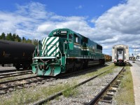 HBRY 5005 SD50 (ex-NREX, exx-UP 9835, exx-MP 5002) sits idle in the HBR yard in Thompson, MB beside VIA #693 which has backed into the station. Passengers have detrained and mill about enjoying the shortened stop on this warm and sunny August 1st afternoon. The trailing passenger car on #693 today is sleeper VIA 8202 Chateau Bienville. It is my home away from home for a couple of days. It won't be long before the call to board is made and the train will once again be on the slow and scenic move to its destination in Churchill, MB.