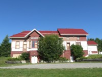 The relocated former Coboconk station rests on a hillside adjacent to legion park. The revision to a walkout front messes up the lines of the building a bit.