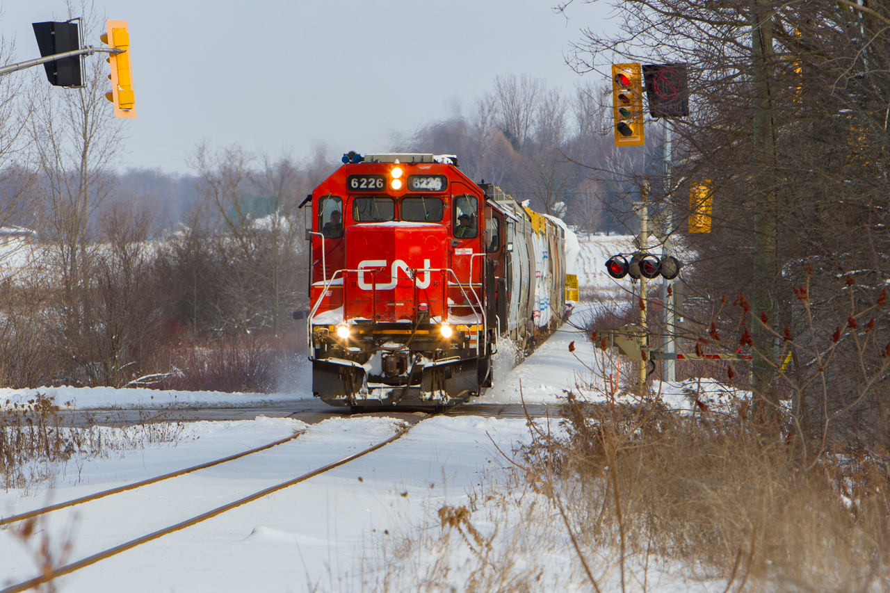 On a crisp December day, GTW 6226 and CN 4028 kick up some snow as they roll through the small town of Baden. One can spot a dimensional load on the tail end bound for GEXR in Goderich and then to Bruce Power if I'm not mistaken. Corrections on that are welcome.