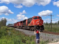 While waiting for CP 528 with my grandson, several CP trucks pulled up to do some signal investigations. The three gentleman were exceptionally nice and my grandson received a few goodies from them. One of them was a nice foam CP engine which he proudly holds up in one arm as he waves from the other. The crewman returns the favour to him as CN 3876 with CP 8200 roar by the 7th Concession in Puslinch. 