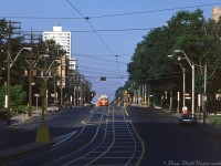 Judging by the lack of cars and pedestrians anywhere, this might be a Sunday morning in August or July (as stores in Ontario were still closed down on the Lord's Day, not to change until 1992). A lone 4500-series A8-class TTC PCC streetcar trundles eastbound on St. Clair Avenue West through midtown Toronto, pausing at <a href=http://www.railpictures.ca/?attachment_id=43883><b>Spadina Avenue</b></a> to let off a passenger before continuing on its way towards the unknown photographer standing at Avenue Road. The destination rollsign appears to read "Yonge Subway" (perhaps St. Clair cars only ran to Yonge on weekends, and not further up <a href=http://www.railpictures.ca/?attachment_id=32380><b>Mount Pleasant</b></a>). A taxi cab sits at Forest Hill Road between calls.<br><br><i>Original photographer unknown, Dan Dell'Unto collection slide.</i>