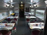 4 1/2 hours late into The Pas, MB on a cool, foggy August 1, 2022 morning, I detrained and snapped a few not often photographed scenes in this remote northern Manitoba town, then climbed back on board and headed to the Skyline car. The tables in the dining area of Skyline VIA 8515 have been set by the crew, and the on-board attendant stands ready to take the breakfast orders. I have my window view chair pulled out at table #3 (second table on the right) where I will soon enjoy a freshly prepared, cooked-to-order breakfast of scrambled eggs, hash-browned potatoes, several strips of bacon (Mmmm bacon!), fresh fruit, and black coffee on this first morning of the wonderful trip to Churchill. What a great way to start another day of train riding! VIA 692 heading south from Churchill sits on a yard track beside our northbound consist. It had been there all night waiting to make the meet in The Pas. The only thing missing on my breakfast plate this morning was several slices of toast. Someone forgot to include any type of bread when loading the kitchen supplies at Winnipeg. Not that I need any more carbs in my daily consumption of groceries! :-)