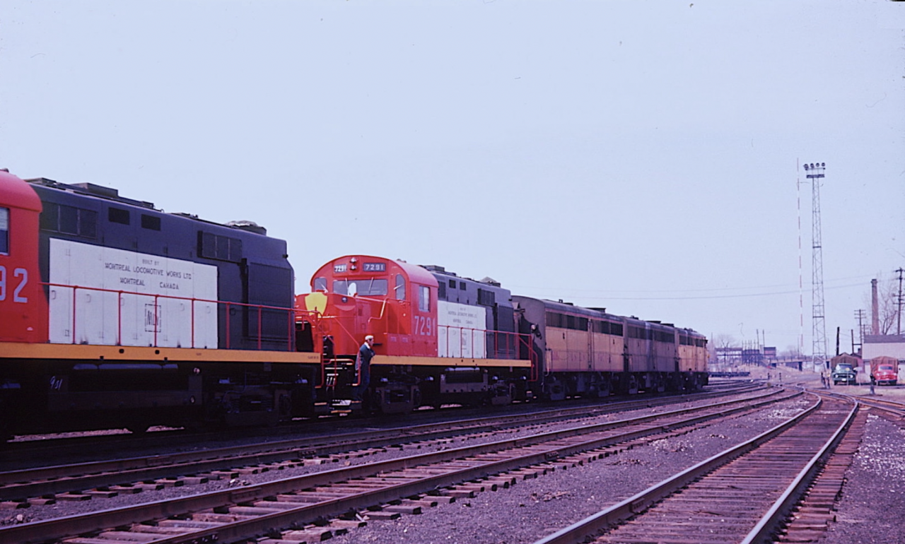 Canadian Pacific leased several first-generation locomotives from the Union Pacific during 1964/65 to handle secondary trains while its top-rated power hauled Russian-bound grain. In this March 1964 photo, UP FA-1 #1627 and two FB-1s arrive at the north end of CP’s Windsor Yard. Tucked in behind the Alco cab units are two National de Mexico RS-11s #7291 and 7292 built by Montreal Locomotive Works. (Note the MLW representative on steps of NdeM 7291). The following morning, the RS11s were ferried across the Detroit River and interchanged with the Wabash which would take them to Kansas City.