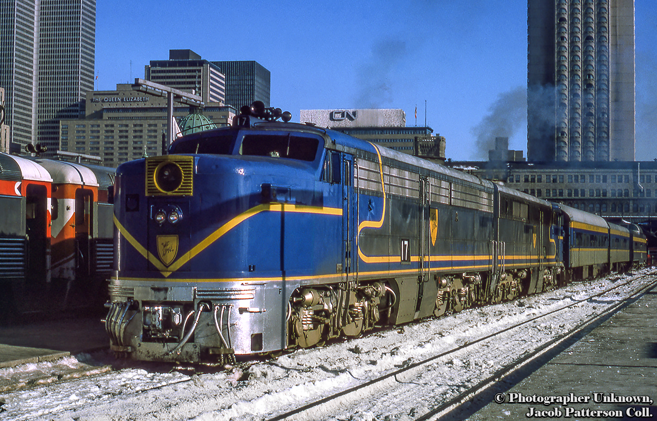 With a pair of Delaware & Hudson ALCO PA-4s upfront, Amtrak's Adirondack prepares to depart Windsor Station in Montreal for New York as train 68 at 0930h.The D&H had operated passenger service into Montreal since 1923 with both its Laurentian by day and Montreal Limited overnight.  These operated into Canada over D&H subsidiary, Napierville Junction Railway, running 27 miles from Rouses Point, New York - Delson and into Montreal via CPR trackage rights.  Endangered by declining ridership by the 1960s, new management in the D&H's passenger department sought to revitalize the operation after negative public response to the potential cancellation.  To do so, the D&H acquired four ALCO PA-1 locomotives in 1967, numbered 16 - 19, from the ATSF.  Wearing a modified ATSF Warbonnet scheme, with D&H blue replacing the red, they would handle the trains of second hand equipment until their final runs on May 1, 1971, as neither The Laurentian or Montreal Limited were included in Amtrak's start up.  In 1974, passenger service over the D&H was to be resurrected by Amtrak as The Adirondack, funded by the New York Department of Transportation.  With limited equipment available to Amtrak at the time, the D&H, then led by Carl Sterzing, provided its PAs and passenger equipment for the runs.  For their return to passenger operation the PAs would be rebuilt from their original ALCO 244 prime mover to ALCO 251s in 1974 by Morrison-Knudsen, and designated ALCO PA-4s.  The rebuilt units served until 1977 when Amtrak replaced the D&H equipment with Rohr Turboliners.  It is also noted, the D&H had acquired a fifth PA for parts in the 1960s, former New Haven 0783.  It was scraped in 1972.The four PA-4s made their way to Mexico in 1978.  All four remain, with two having returned to the states:Former D&H 16 under restoration at the Museum of the American Railroad, Frisco, Texas.Lead unit D&H 17 preserved at the National Museum of Mexican Railroads.railing unit D&H 18 under restoration by Doyle McCormack as NKP 190 in Portland, Oregon.Forer D&H 19preserved at the National Museum of Mexican Railroads.This scene from the platform at CP's Windsor station includes RDCs at left with differing letter boards, one action red, the other maroon; the former CP Chateau Champlain Hotel, opened for Expo67, and now operated under Marriott.  The CN Rail headquarters building looms over the scene, and The Queen Elizabeth hotel, originally built by the CNR, and now operated by Fairmont.More D&H PA Canadian action:D&H 16 near Montreal West by Neil ComptonD&H 18 at Montreal West by Neil ComptonD&H 18 at Westmount by Steve DankoOriginal Photographer Unknown, Jacob Patterson Collection Slide.