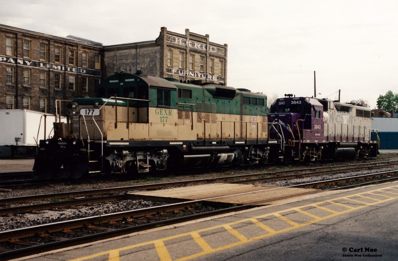 During spring 1999 and less than one year after the Goderich-Exeter Railway (GEXR) had acquired the Guelph Subdivision and related spurs, units formally assigned to the Goderich Subdivision could be seen operating on the fairly still recently absorbed trackage.  

Here GEXR 177 and 3843 await their next assignment across from the VIA Rail station during a quiet morning in Kitchener.