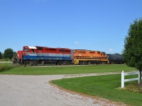 Because it was a nice day, while on our way back from an overnighter in Goderich and coming across RLK 4095 with RLHH 2117 with about 14 cars in tow heading up to Clinton Jct., we decided to follow it when we realized it was heading over to the Exeter sub.   Much more favourable sun angle.
The view here is at Mill Rd crossing in Brucefield, and the grey building seen between the units in the background is the Millroad trailer manufacturing plant.