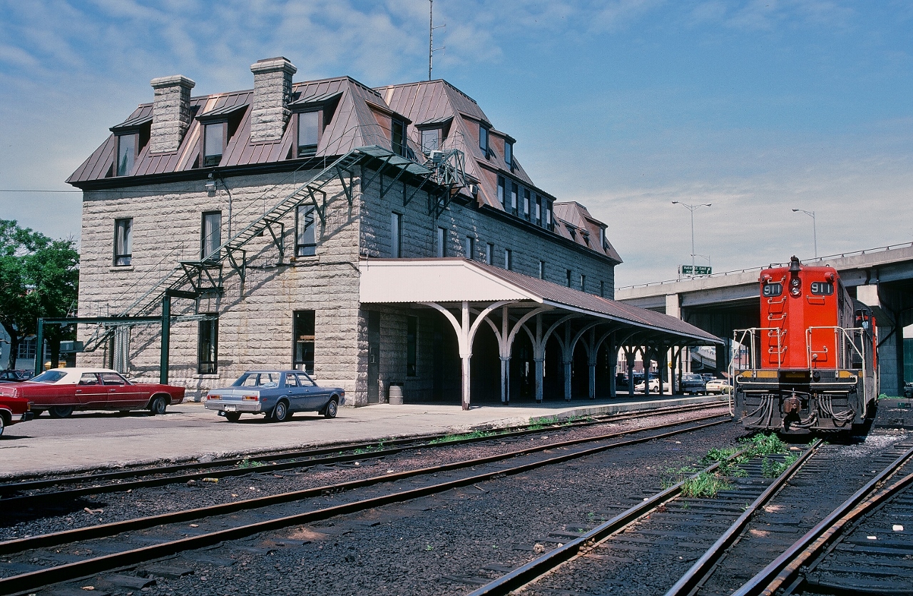 Located at 495 Water Street the circa 1901 built Newfoundland Railway station is hosting GMD 1956 built NF210 #911 and a sister on a sunny August morning.


At St. John's Newfoundland, August 8, 1982 Kodachrome by S.Danko


As at 1982 the TT #911 future: to Chile in 1988 renumbered  FCAB 1415. A total of seventeen NF210 sisters, in 1988 and 1994, have been acquired by FCAB: British company name: Antofagasta (Chili) & Bolivia Railway or FCAB for short. 


Noteworthy: FCAB outbound traffic ( to the ocean freighters)  is nitrate ( for explosives), copper and more recently lithium brine. Inbound traffic is sulfuric acid.  The FCAB railway is now part of the transport division of mining company Antofagasta plc. 


   High Rail Newfoundland style:


       TT#204  


sdfourty