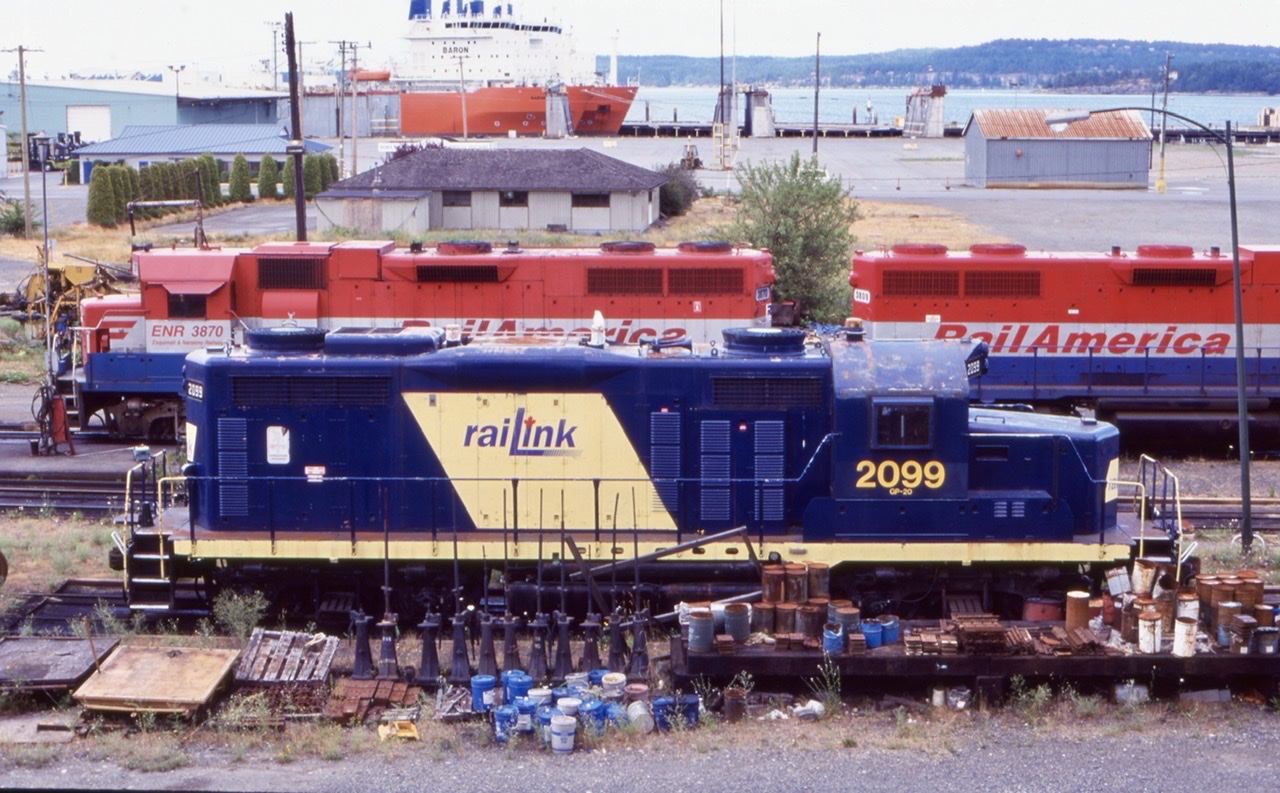 I have always had an interest is Canada’s island railroads. Sadly the years have not been kind to them and most have lost their rails. Thankfully my 2003 trip allowed a short period of time to visit Vancouver Island. At that time RailAmerica was still operating the former CP lines on the island. The two GP38’s seen here at the time were the main power, with Railink GP20 kept as back up. While marked as a GP20, the 2099 is internally a GP9 and the split exhaust stacks illustrate this. The unit was built for the CB&Q as a GP20 but rebuilt years later. I have crossed paths with the unit years earlier as it was assigned to the RLK/SOR out of Brantford but numbered back then as 1751.