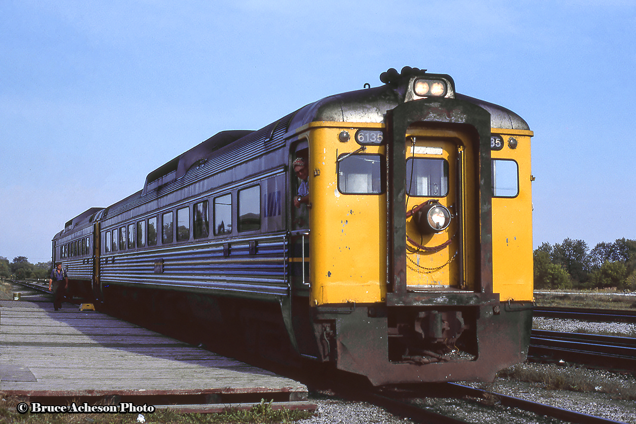 Just over 40 years ago, VIA Rail 189 with Budd RDCs 6135, 6211 poses at the Havelock station before departing on the second last run to Toronto.  Engineer W. E. (Ted) Beam stands in the doorway, and he will hop down for a photo with his train shortly.  The final westbound run would take place the following day, Monday, September 6, 1982.  In a few years time, the Havelock train will be reinstated on June 3, 1985, before being cut for good in January 1990.More of the “Havelock Budds”:Havelock, July 1976, Arnold MooneyBurketon, July 1976, Doug HatelyHavelock, August 1977, Arnold MooneyA series of shots by Steve Danko, showing the second last run, September 5, 1982:Arriving PeterboroughPulling down the shoe flyThe platform scene at PeterboroughToronto-bound through PontypoolLast Day at Peterborough, Eric MayHavelock after the return, August 1986, Steve Danko