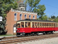 Edmonton Radial Railway Society's car #42 draws up to the car stop outside the 1893 Fire Hall at Fort Edmonton Park. When built in 1893 the fire hall sat at 98 Street and 101 Avenue and served as town office, police station and fire hall.  The street car was built in 1912 by the St. Louis Car Company for the City of Edmonton and was in service until the end of street car operations in 1951.  After restoration by ERR it was put into service in 1984 at the Park where it has been the reliable workhorse ever since.