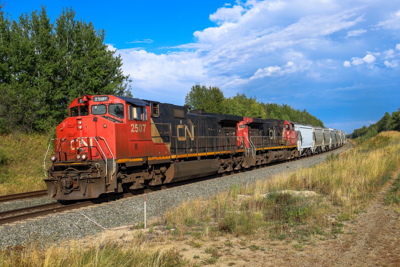 Taylor, Wisconsin to Fort St. John, BC sand train S 77181 02 highballs through Stony Plain with a pair of Canadian Cab GEs; CN 2507, CN 2514 and 89 frac sand loads.