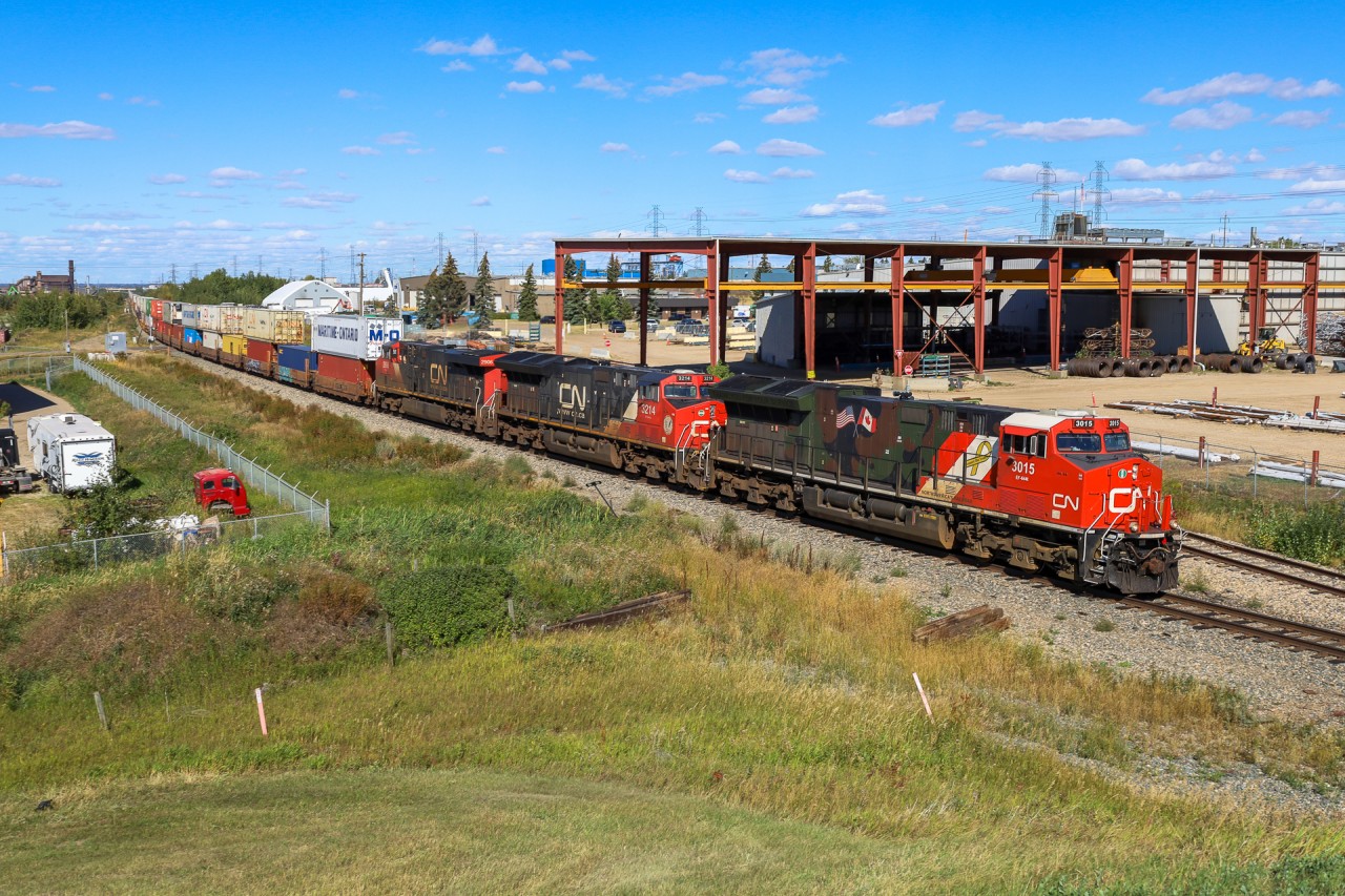 Z 11531 07 highballs through the industrial centre of Edmonton, bound for Calgary with CN 3015 leading.