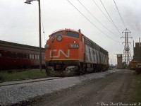 As well as working the Steel Train out of Hamilton, CN's rebuilt F-units also found themselves on local wayfreight and work trains in the 80's. Here, CN F7Au's 9164 and 9169 sit in the TTR's Don Yard south of Cherry Street awaiting their next duties. CP business car 60 sits on an adjacent track.
<br><br>
What appears to be a CN switcher and transfer caboose sit on another track near the old Don Yard yard tower (single-level at the top, like the ones at Mimico and Canpa, but unlike the one at Bathurst Street). Also in the background is the Lever Brothers soap factory (opened in the early 1950's, closed in the late 2000's) at the foot of the Don River. Today the F's and yard tower are gone, but Don Yard still sees use as a layover facility for GO Transit.
<br><br>
<i>Original photographer unknown, Dan Dell'Unto collection.</i>